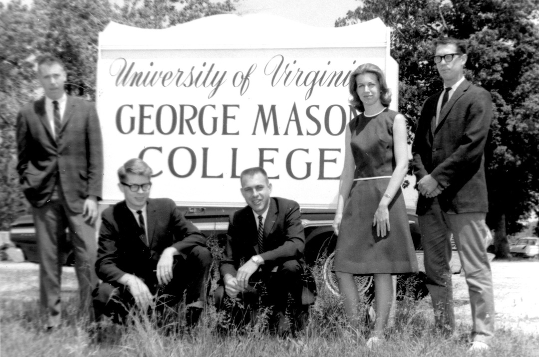Newly-elected student government officers in front of the George Mason College sign